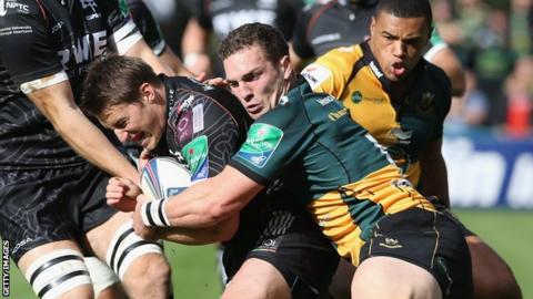 Ospreys' Jeff Hassler is held by George North