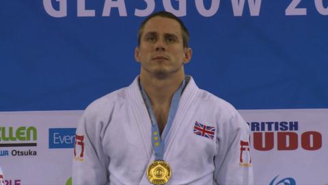 Euan Burton with gold medal on podium