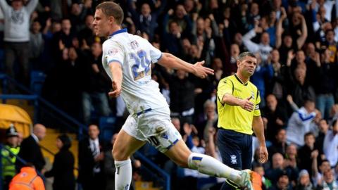 Birmingham captain Paul Robinson looks on dejected as two-goal Leeds striker Matt Smith celebrates at Elland Road