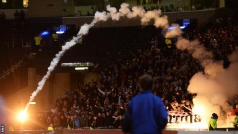 A flare flies from the area populated by Croatia fans