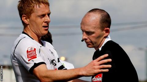 Referee Mike Dean with Swansea's Garry Monk