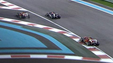 Fernando Alonso crashes over the kerbs in the Abu Dhabi Grand Prix as he battles with Jean-Eric Vergne after exiting the pits.