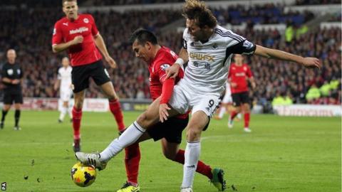 Swansea forward Michu battles with Cardiff midfielder Gary Medel