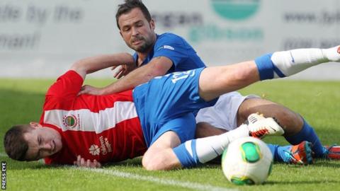Crusaders striker David Rainey in action against Billy Joe Burns of Linfield