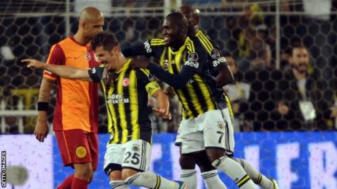 Fenerbahce's Emre Belozoglu celebrates with team-mates after scoring against Galatasaray
