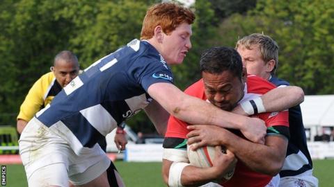 Jack Tovey (left) makes a tackle