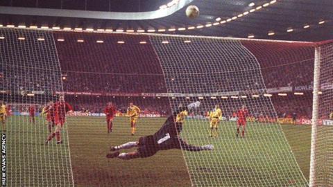 Paul Bodin strikes his penalty against the bar