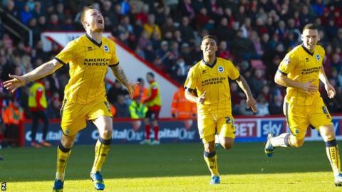 Ashley Barnes (left) celebrates his equaliser for Brighton against Bournemouth
