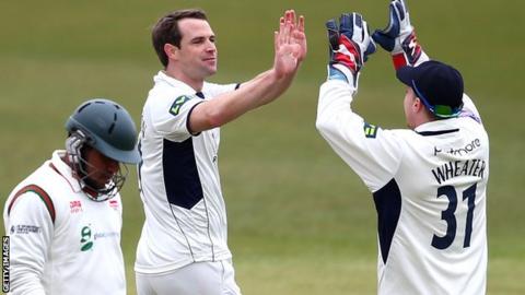James Tomlinson (centre) takes a wicket for Hampshire