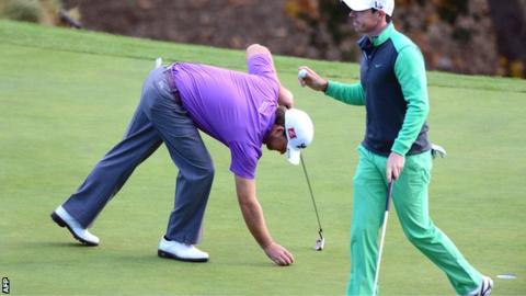 Graeme McDowell and Rory McIlroy at the 18th green