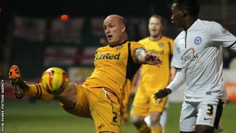 Newport County's David Pipe and Kgosi Ntlhe of Peterborough United