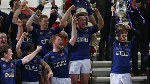 Queen's captain Stuart McIlwaine lifts the Senior Cup