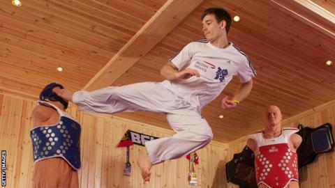 Aaron Cook of Great Britain poses for pictures during a British Airways photo feature at a specially constructed gym.