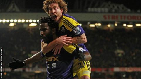 Swansea City's Wilfried Bony celebrates with Jose Canas