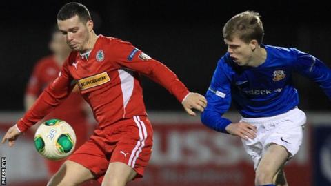 Cliftonville winger Martin Donnelly shields the ball from Chris Curran