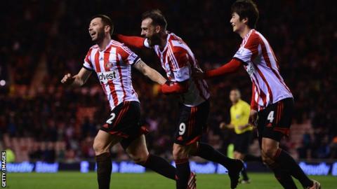 Phil Bardsley of Sunderland (left) celebrates Ryan Giggs of Manchester United scoring an own-goal