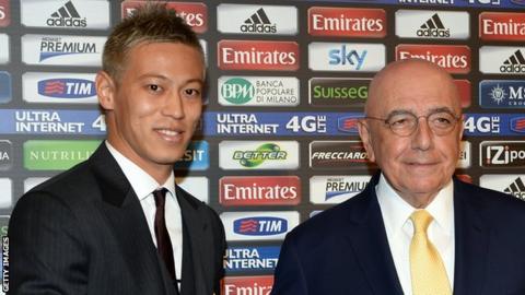 Keisuke Honda shakes hands with AC Milan's general director Adriano Galliani