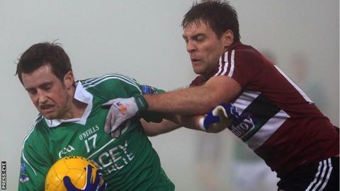 Fermanagh's Niall McElroy is challenged by James Duffy of St Mary's at Brewster Park.