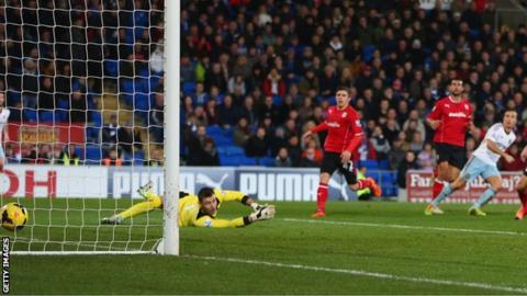 Cardiff keeper David Marshall is helpless to prevent Mark Noble from adding a second, decisive West Ham goal