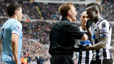 Referee Mike Jones (centre) speaks with Newcastle midfielder Cheick Tiote (right) as Manchester City's Samir Nasri (left) watches on
