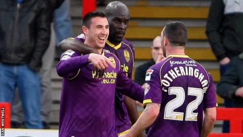Callum Ball celebrates with his Notts County teammates