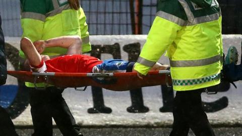 Aaron Burns is carried off during Saturday's win at Ballymena