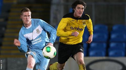Ballymena's Darren Boyce in action against Dan McMurray of H&W Welders