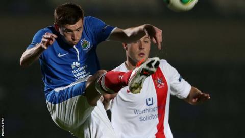 Billy Joe Burns battles with Mark McClelland during the County Antrim Shield clash between Linfield and Ards in September