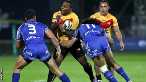 Papua New Guinea's Enoch Maki (centre) is tackled by Samoa's Sia Soliola and Tim Lafai