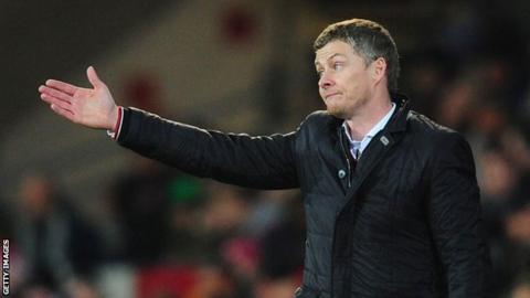 Ole Gunnar Solskjaer gesticulates to his players during a game