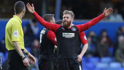 Adam Clayton celebrates his goal