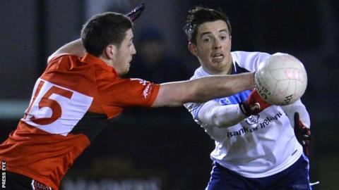 UCC forward Paul Geaney challenges UUJ's Ronan O'Neill in the final