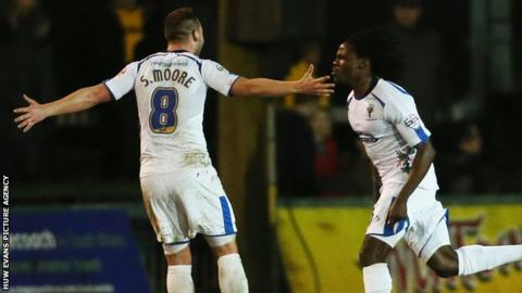 AFC Wimbledon's Kevin Sainte-Luce celebrates after scoring his side's winner against Newport