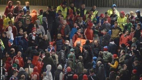 Stewards go into the Cliftonville end during the game against Linfield