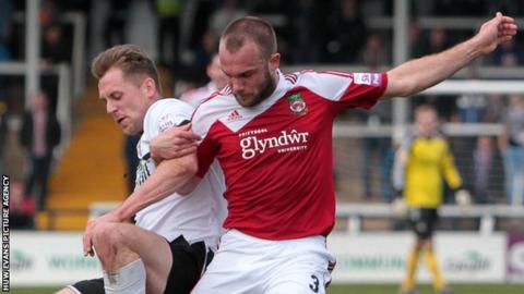 Neil Ashton battles for the ball with Hereford's Dan Walker.