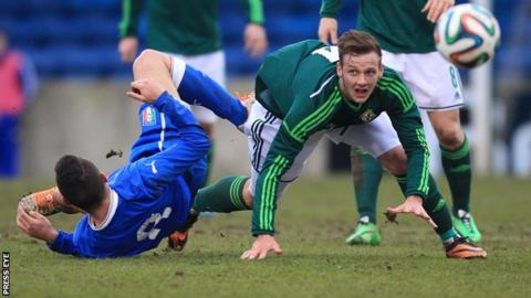 Northern Ireland's Seanan Clucas battles with Federico Viviani in the Under-21 international at Mourneview Park
