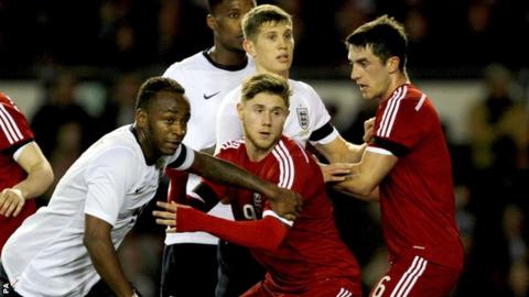 England's Saido Berahino (left) and Wales Wes Burns