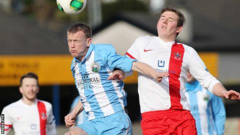 Warrenpoint's Towm Liam Bagnall beats Ross Arthur of Ards to the high ball