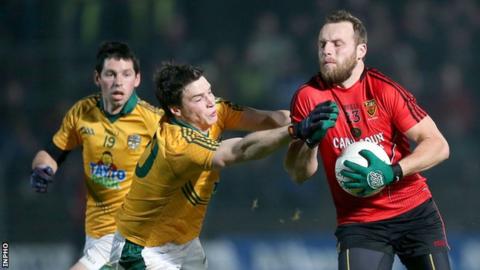 Down's Ambrose Rogers is challenged by Meath's Donncha Tobin at Navan