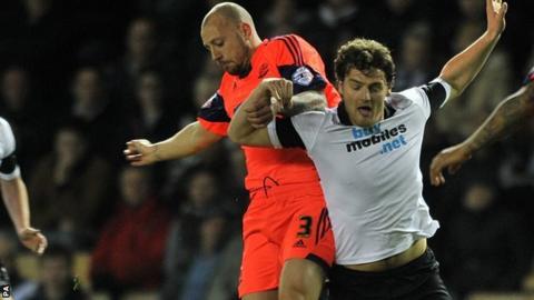 Bolton full-back Alan Hutton (left) challenges Derby striker Chris Martin