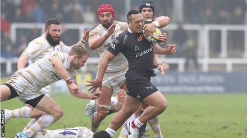 Newcastle Falcons centre Sinoti Sinoti holds off several Worcester Warriors players