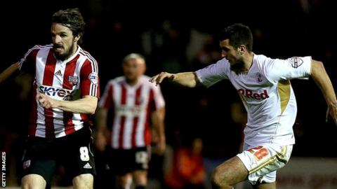 Brentford's Jonathan Douglas and Crawley Town's Gary Dicker (right)