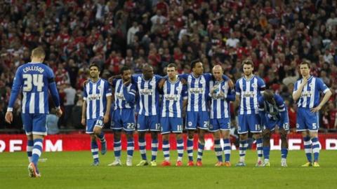 Jack Collison walks back to his team-mates after having his penalty saved