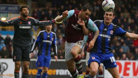 Danny Ings is challenged by Dean Whitehead