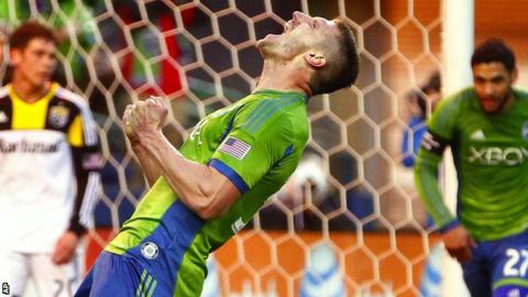 Seattle Sounders midfielder Kenny Cooper celebrates after scoring