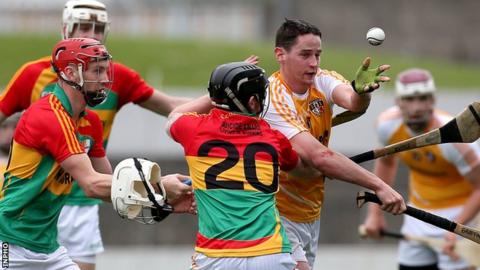 Three Carlow players close in on Antrim's Aaron Graffin