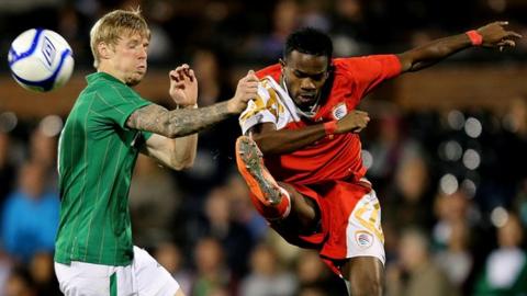 Andy Keogh battles with Saad Al Mukhaini in the September 2012 friendly between the countries at Craven Cottage