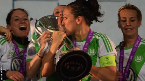 Captain Nadine Kessler kisses the Champions League trophy