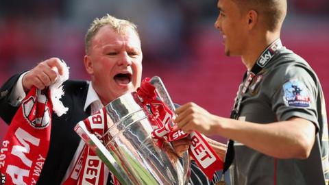 Rotherham United's Manager Steve Evans and James Tavernier celebrate with the trophy after the match