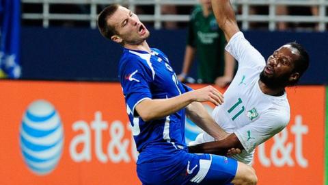 Bosnia's Senijad Ibricic (left) and Didier Drogba of Ivory Coast